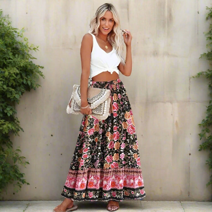Vintage boho maxi skirt in pink showing flowing floral print, styled look